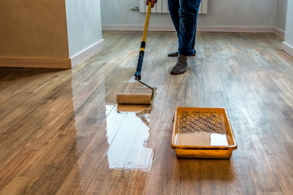 a person varnishing a floor