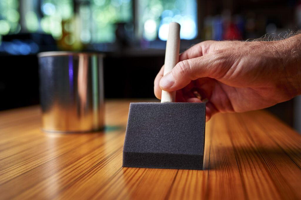 a man varnishing furniture