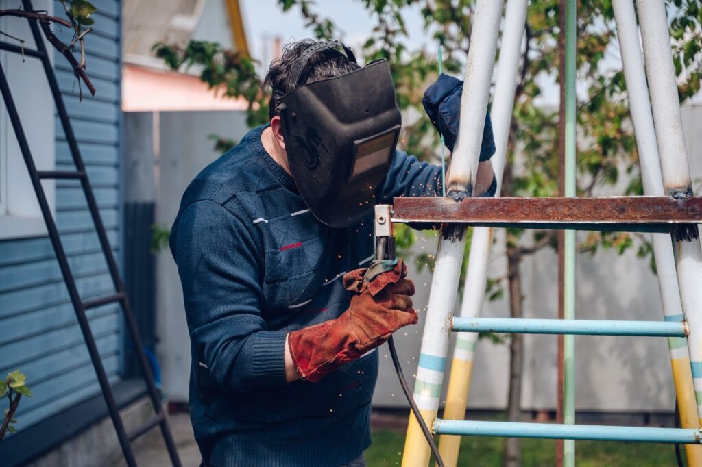 A person welding outside