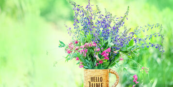 Hello,June.,Meadow,Flowers,In,Cup,On,Wooden,Table,In